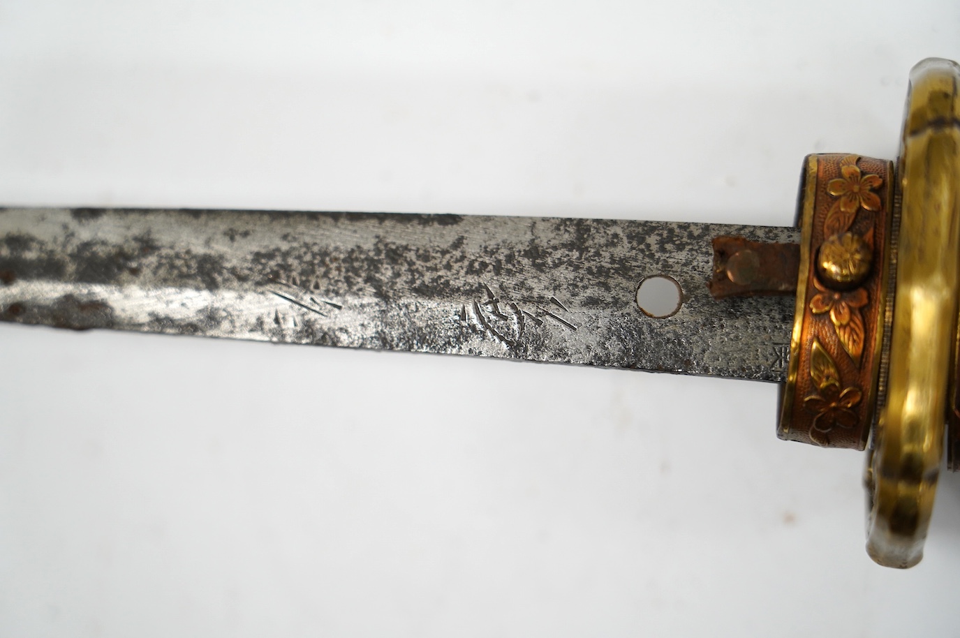 A Japanese WWII army officer’s sword Katana, blade 57.9cm, signed and dated with Seki Arsenal stamp, retaining good polish, in shin gunto mounts with leather combat cover on hilt and scabbard, the latter with plate stamp